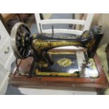 An early 20th century oak cased Singer sewing machine serial number R808656, patented 1886