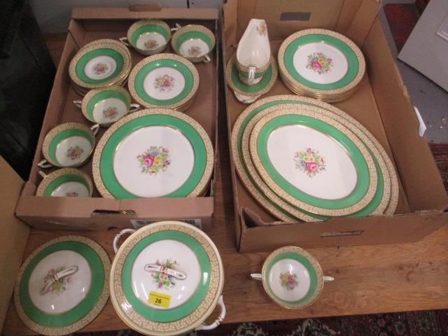 A Paragon china dinner service decorated with a bouquet of flowers and a green band