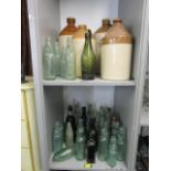 A collection of early 20th century glass bottles, many advertising local companion, including