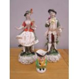 A pair of Kunst German porcelain early 20th century figurines A/F and a Devon pottery small Toby jug