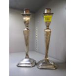 A pair of early 20th century silver candlesticks