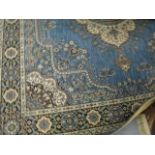 A Wilton wool pile large rug with a floral pattern on a blue ground with triple guard borders,