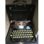 A vintage black Corona typewriter in case