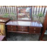 A reproduction mahogany Stag dressing table and a matching chest of drawers