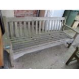 A large teak garden bench 32"h x 76 3/4"w