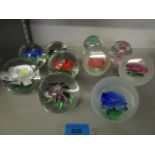 A group of assorted glass paperweights to include Chinese flower weights