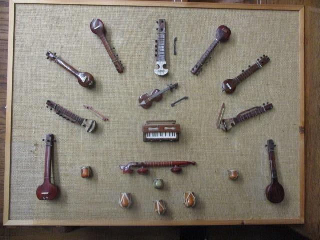 A display of Indian and other miniature wooden musical instrument models