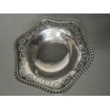 Nayler Brothers - a George V silver dish with cast, fluted rim, pierced decoration, standing on