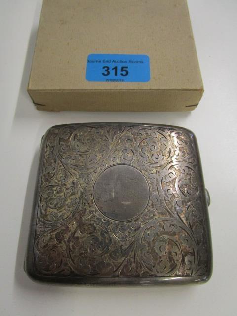 An Edwardian silver cigarette case with floral scrolled decoration, Birmingham 1919, marks for