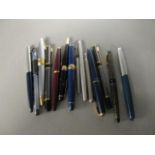 A collection of vintage fountain pens to include a Sheaffer pen with a 14k gold nib, a Parker 51