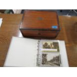 A rosewood writing slope with fittings, together with a selection of vintage postcards within an