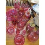 A collection of early to mid 20th century cranberry glassware to include an oil lamp
