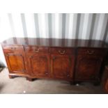 A reproduction mahogany sideboard with four short drawers and four cupboard doors 34"h x 76"w