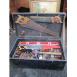 A vintage toolbox containing mixed woodworking tools to include saws, planes and other items