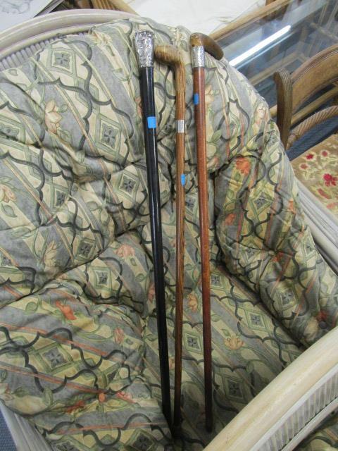 Three Victorian and later walking sticks, each with a silver ferrel or handle