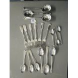 An early 20th century set of three soup spoons, dinner spoons, smaller dinner spoons and three