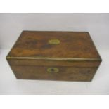 A Victorian figured walnut, military style writing slope with brass edges, enclosing a pair of