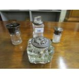 Three glass and silver dressing table bottles, to include one with an inlaid silver and