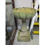 Weathered composition bird bath, on baluster base