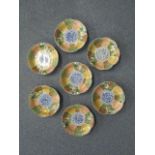 A group of seven 19th century old Japanese Imari petal-shaped dishes, the centre depicting a