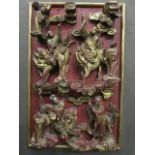 A 20th century Chinese red painted and gilt carved wooden panel with figures riding Pixiu and a deer