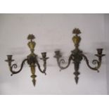 A pair of early 20th century, gilt metal, twin branch wall sconces with vase of flowers over