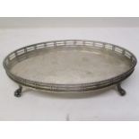 An early 20th century oval silver teapot stand by Tessiers, London 1931, with a pierced gallery on