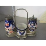 A Queen Anne style condiment set in a blue case having pepperette, mustard and salt with two spoons