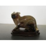 A Chinese carved chalcedony model of a rabbit on a wooden base, probably early to mid 20th century