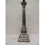 A late Victorian silver plated lamp with a Corinthian capital, a reeded column, on a plinth with