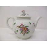 A mid/late 18th century bulbous teapot with a domed lid, flower finial, applied leaves, decorated