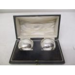 A pair of early 20th century silver, curved napkin rings by Josiah Williams & Co, London 1918, cased