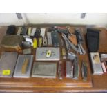 A collection of pen knives, lighters and four cigarette cases