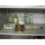 A small group of vintage ships in bottles, glass bottles and a stoneware bottle