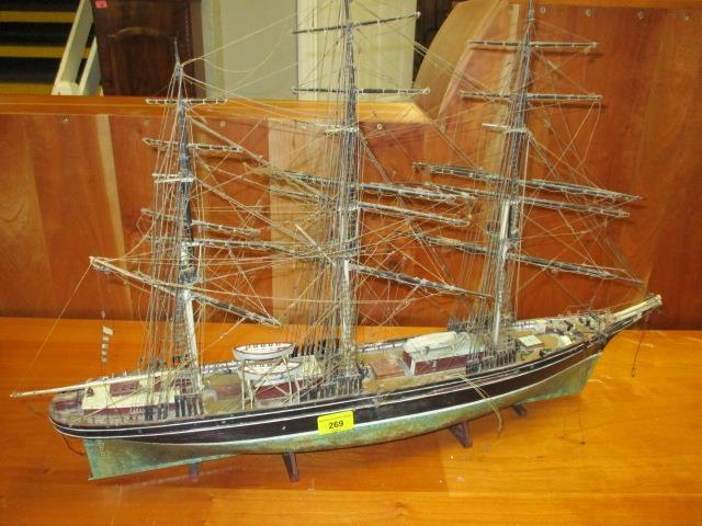 A painted wooden model of a triple mast ship