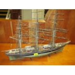 A painted wooden model of a triple mast ship