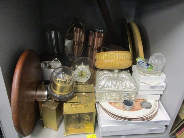 A mixed lot to include placemats, napkin rings, a Lazy Susan and mantel clocks