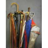 A mixed lot of walking canes and shooting sticks/umbrellas