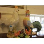 Four modern painted pottery models of chickens and one of a cockerel