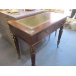 An early 20th century mahogany side desk with leather scriber