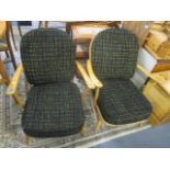 A pair of Ercol style beech spindle back armchairs