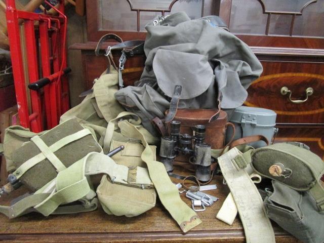 A selection of military issue equipment to include belts, webbing, water bottles, canvas bags,