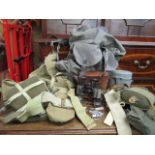A selection of military issue equipment to include belts, webbing, water bottles, canvas bags,