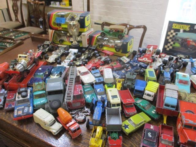 A large mixed lot of toy vehicles to include Corgi McLaren M19A and other items