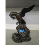 A bronzed metal sculpture of an eagle