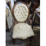 A Victorian spoon back mahogany salon chair having a serpentine front and two front cabriole legs