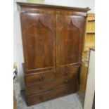 A Victorian Gothic inspired mahogany linen press with a pair of panelled doors over two short and
