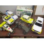 The component parts of six radio controlled cards and a Rover Mini Cooper 1/10" electric powered car