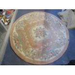 A Chinese pink ground circular rug