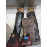 A pair of leather riding boots enclosing vintage treen boot stays, a pair of modern children's